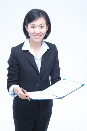 Young Asian businesswoman posing with a folder - isolated on whiteの写真素材