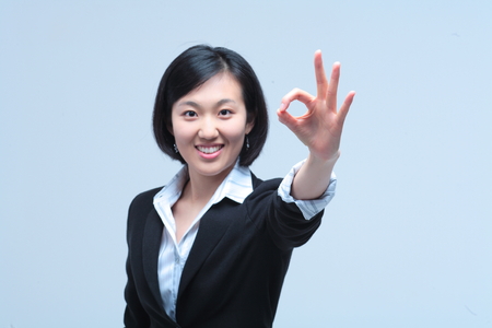 Young Asian businesswoman posing in the studio - isolated on whiteの写真素材