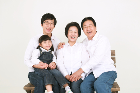 Three generation asian family dressed casually - isolated on whiteの写真素材