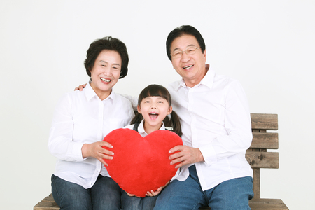 Three generation asian family dressed casually - isolated on whiteの写真素材