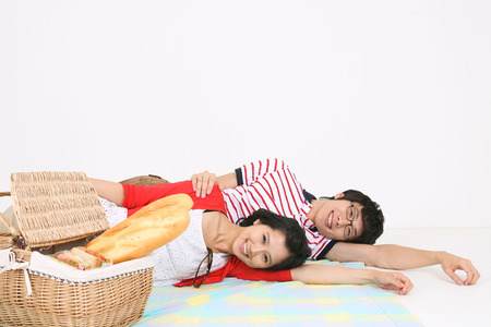 Young asian family picnic - isolated on whiteの写真素材