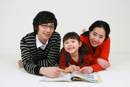 Asian young couple with a little girl - isolated on whiteの写真素材