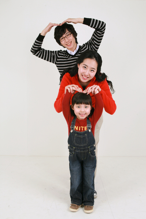 Asian young couple with a little girl - isolated on whiteの写真素材