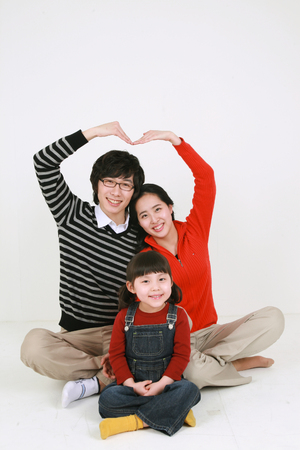Asian young couple with a little girl - isolated on whiteの写真素材