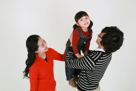 Asian young couple and a little girl - isolated on whiteの写真素材