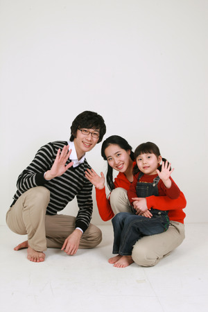 Asian young couple with a little girl - isolated on whiteの写真素材