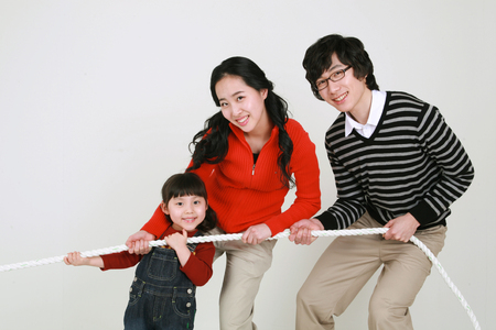 Asian young couple with a little girl - isolated on whiteの写真素材