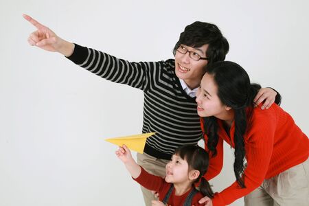 Asian young couple with a little girl - isolated on whiteの写真素材
