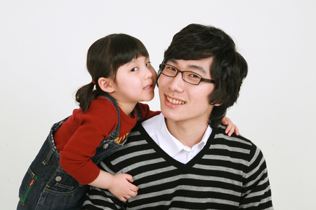 Asian young couple and a little girl - isolated on whiteの写真素材