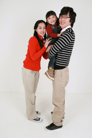 Asian young couple and a little girl - isolated on whiteの写真素材