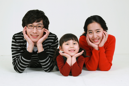 Asian young couple with a little girl - isolated on whiteの写真素材