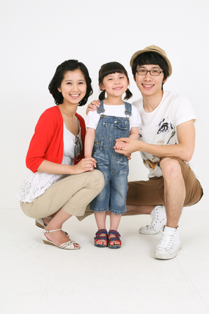 Young asian family picnic - isolated on whiteの写真素材