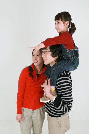 Asian young couple and a little girl - isolated on whiteの写真素材