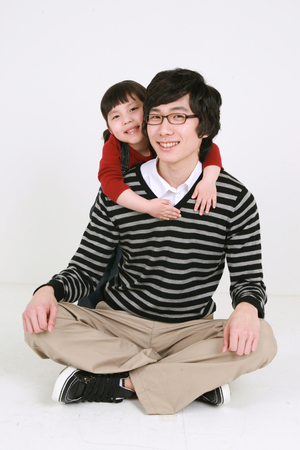 Asian young couple and a little girl - isolated on whiteの写真素材