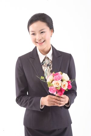 Asian businesswoman in uniform posing in the studio - isolated on whiteの写真素材