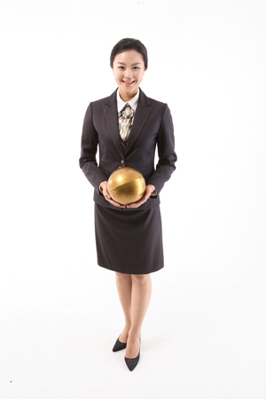 Asian businesswoman in uniform posing in the studio - isolated on whiteの写真素材