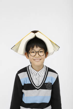 Asian kids with education concept- Isolated on studio shotの写真素材