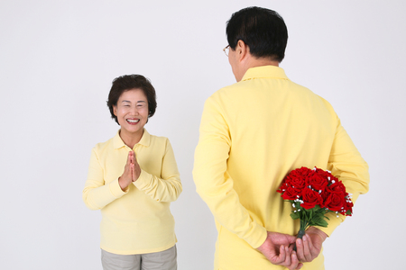 Old asian couple's happy daily life - isolated on whiteの写真素材