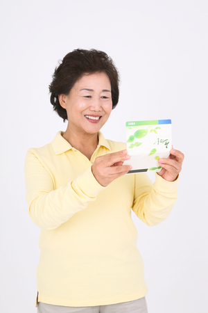 Old asian couple's happy daily life - isolated on whiteのeditorial素材