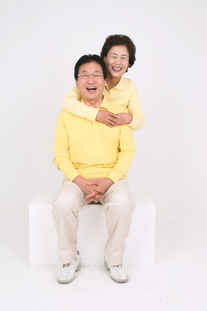 Old asian couple's happy daily life - isolated on whiteの写真素材