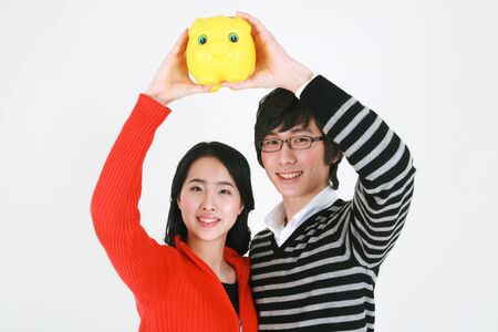 Young asian couple in a studio - isolated on whiteの写真素材