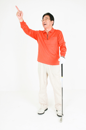 Old asian couple playing golf - isolated on whiteの写真素材