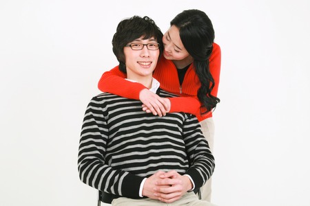 Young asian couple in a studio - isolated on whiteの写真素材