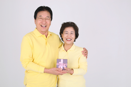 Old asian couple's happy daily life - isolated on whiteの写真素材