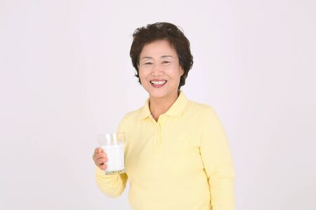 Old asian couple's happy daily life - isolated on whiteの写真素材