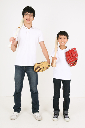 Asian boy and man playing baseball - isolated on whiteのeditorial素材