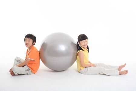 Working out with asian children - isolated on whiteの写真素材