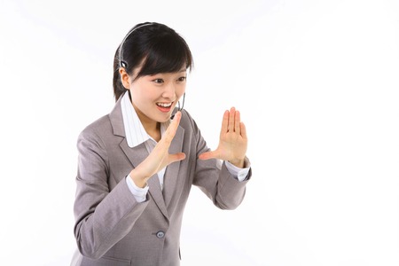 Asian call center operator posing in the studio - isolated on whiteの写真素材