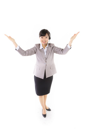 Asian call center operator posing in the studio - isolated on whiteの写真素材