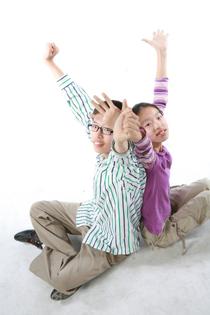 Asian brother and sister in studio - isolated on whiteの写真素材