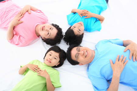 Asian grand parents and two kids - isolated on white