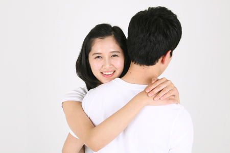 Asian couple playing game in studio - isolated on whiteの写真素材