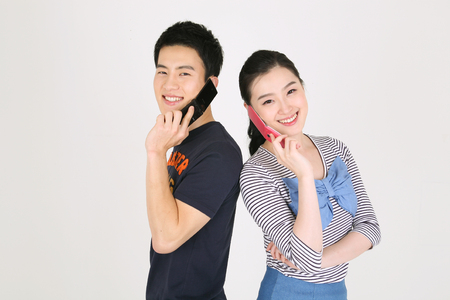 Asian couple in studio - isolated on whiteの写真素材