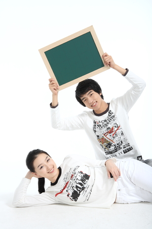 Asian young couple in studio - isolated on whiteの写真素材