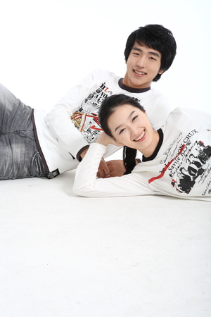 Asian young couple in studio - isolated on whiteの写真素材