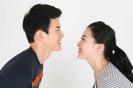 Asian couple in studio - isolated on whiteの写真素材