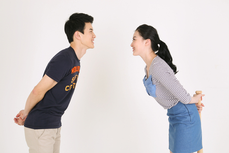 Asian couple in studio - isolated on whiteの写真素材