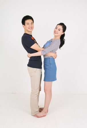 Asian couple in studio - isolated on whiteの写真素材