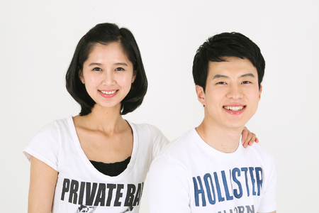 Asian couple playing game in studio - isolated on whiteのeditorial素材