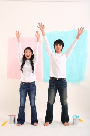 Young asian couple painting in studio - isolated on whiteの写真素材