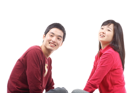 Young asian couple in studio - isolated on whiteの写真素材