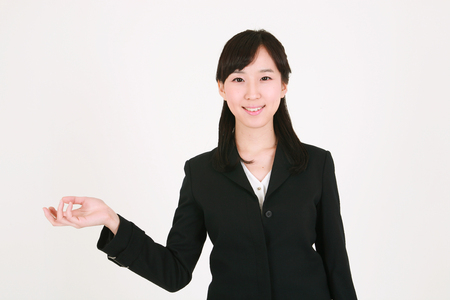 Young Asian businesswoman posing in the studio - isolated on whiteの写真素材