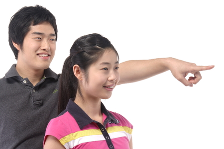 Young asian couple in studio - isolated on whiteの写真素材