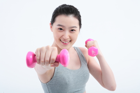Young Asian woman working out - isolated on whiteの写真素材