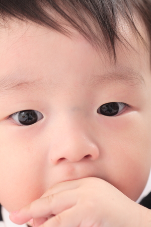 Asian baby boy in studio - isolated on whiteの写真素材