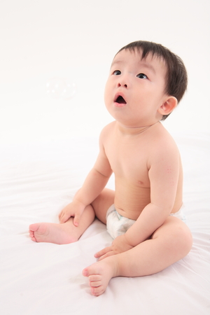 Asian baby boy in studio - isolated on whiteの写真素材